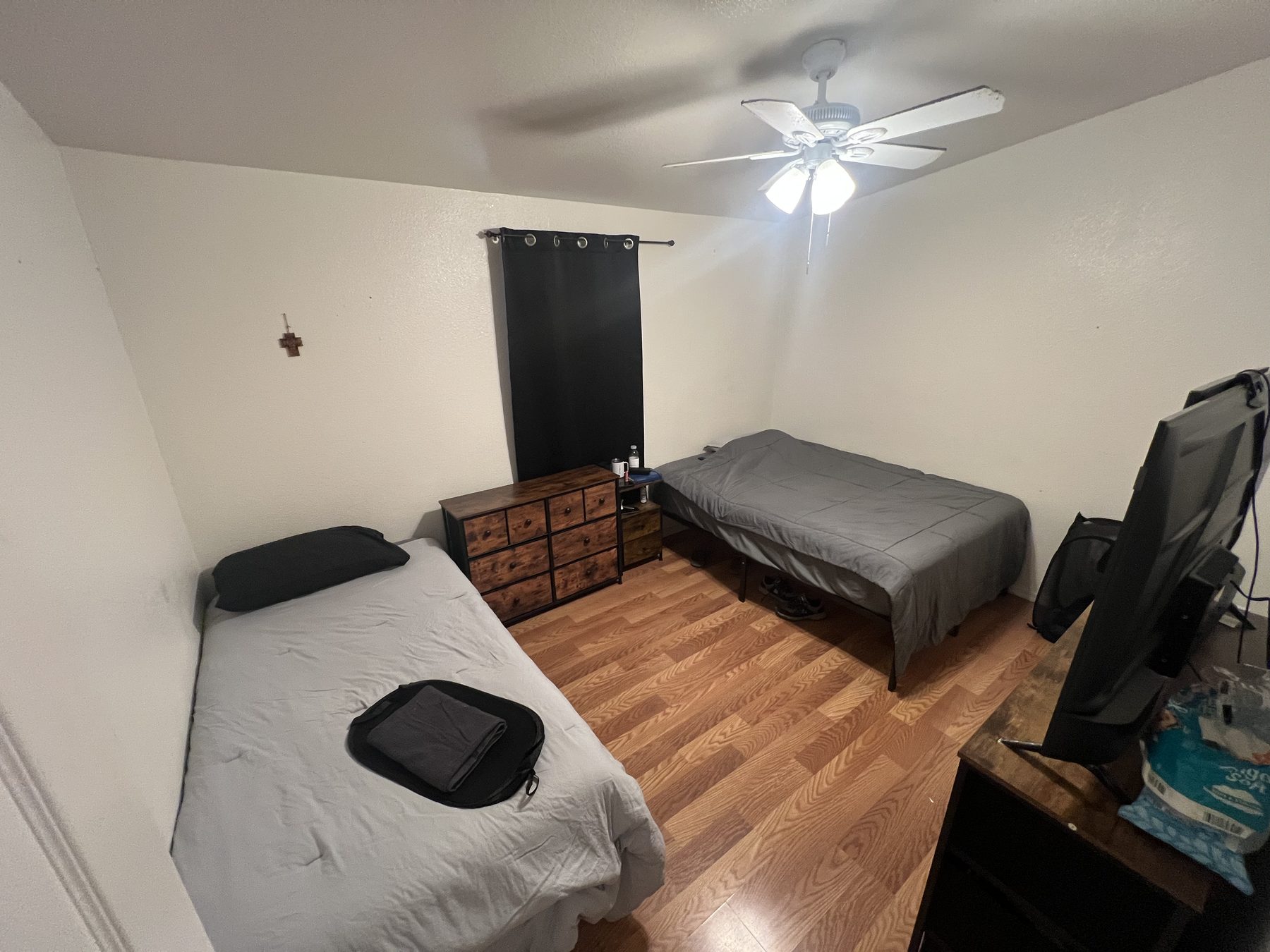 Shared bedroom with a wooden cross on the wall