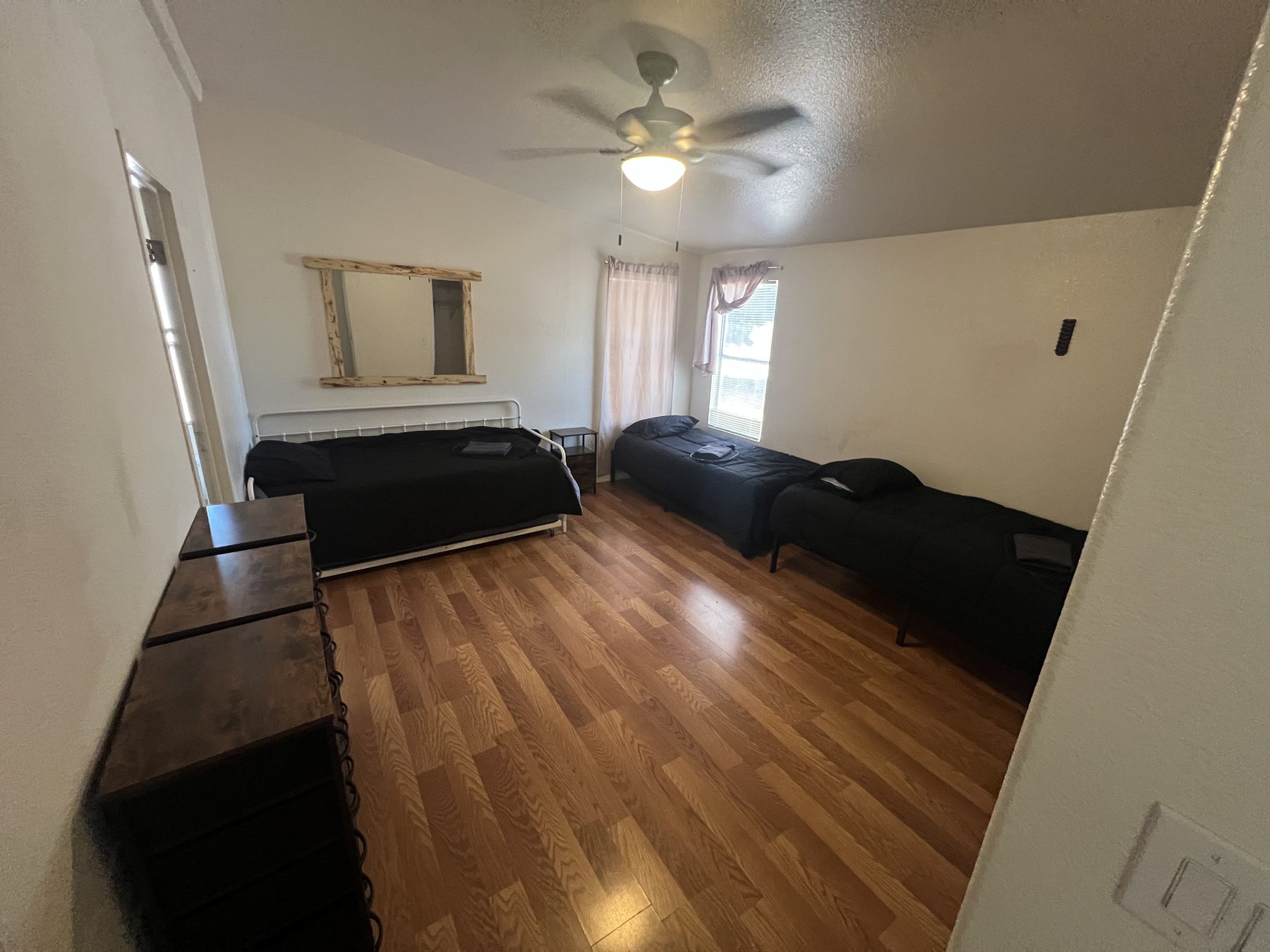 Bright shared bedroom with three beds